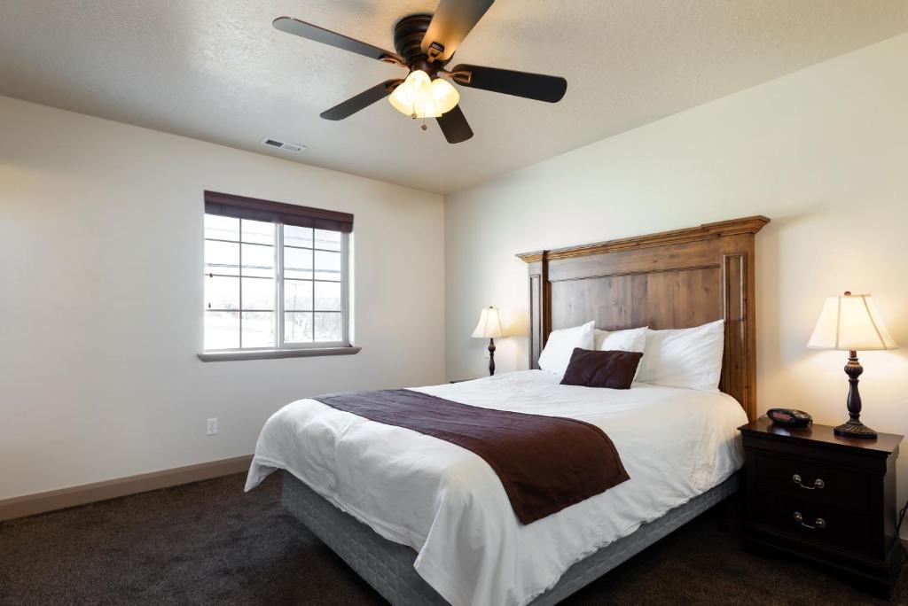 a bedroom with a bed with a ceiling fan at Duchesne Suites in Duchesne