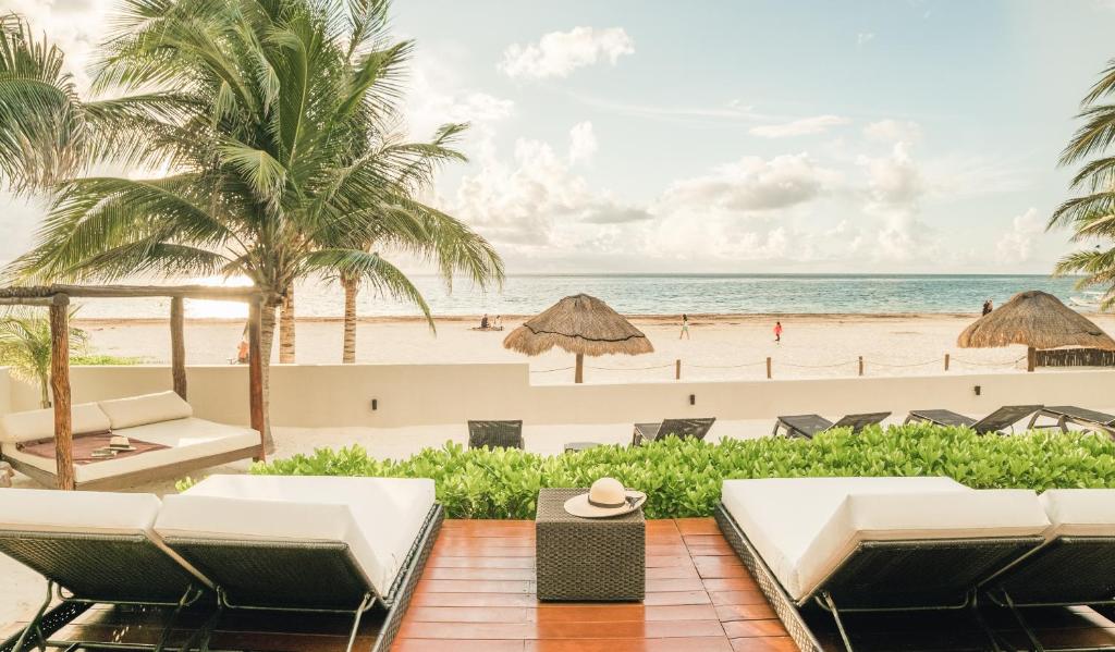 a view of the beach from the balcony of a resort at Casa Brisa y Mar in Puerto Morelos