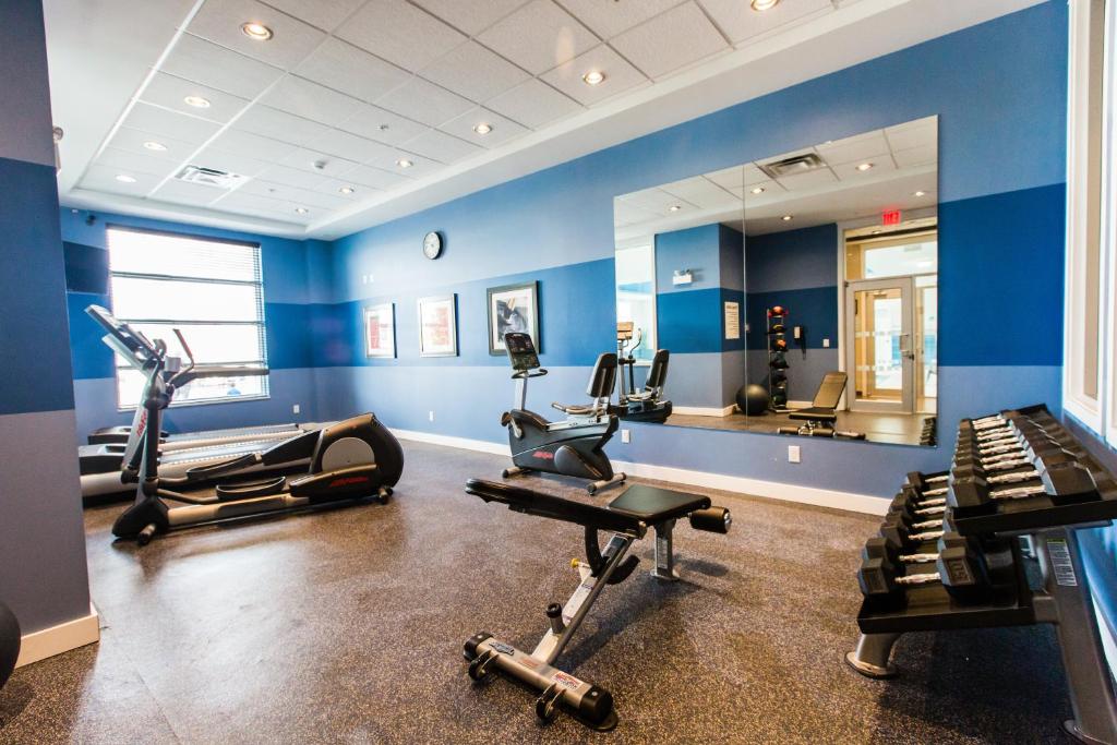 a gym with several tread machines and a mirror at Holiday Inn Express & Suites Spruce Grove - Stony Plain by IHG in Spruce Grove