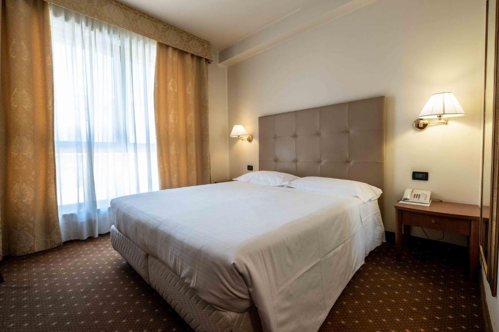 Postel nebo postele na pokoji v ubytování La Pieve Hotel