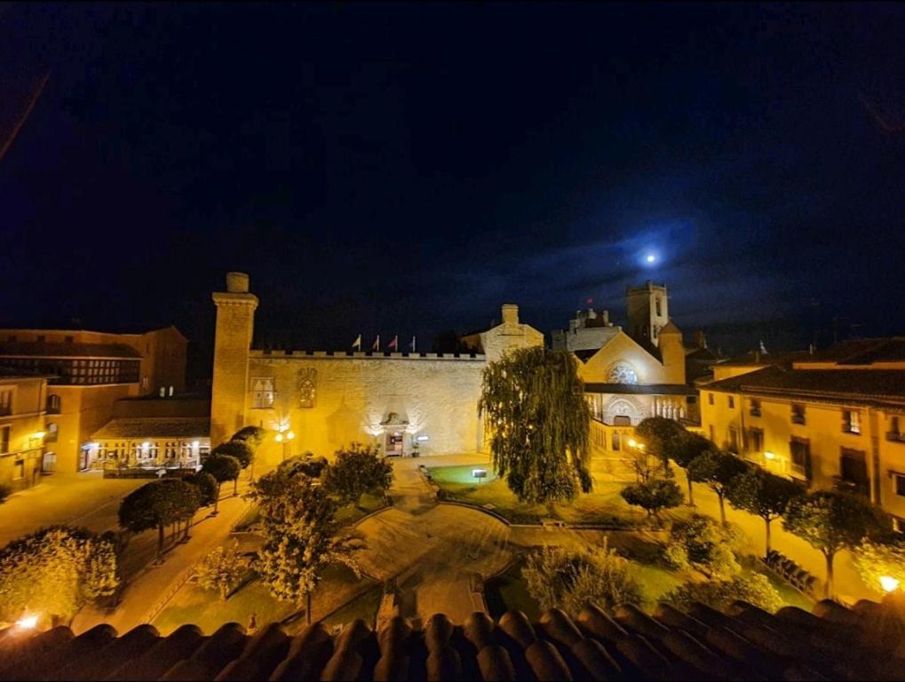 a view of a building at night with lights at B&B La Atalaya in Olite