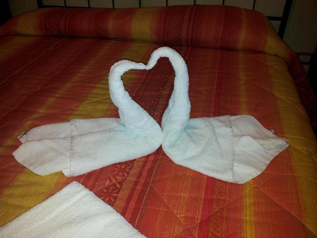 two towels shaped like swans laying on a bed at Casa Vacanze Trapani Vico compagni in Trapani