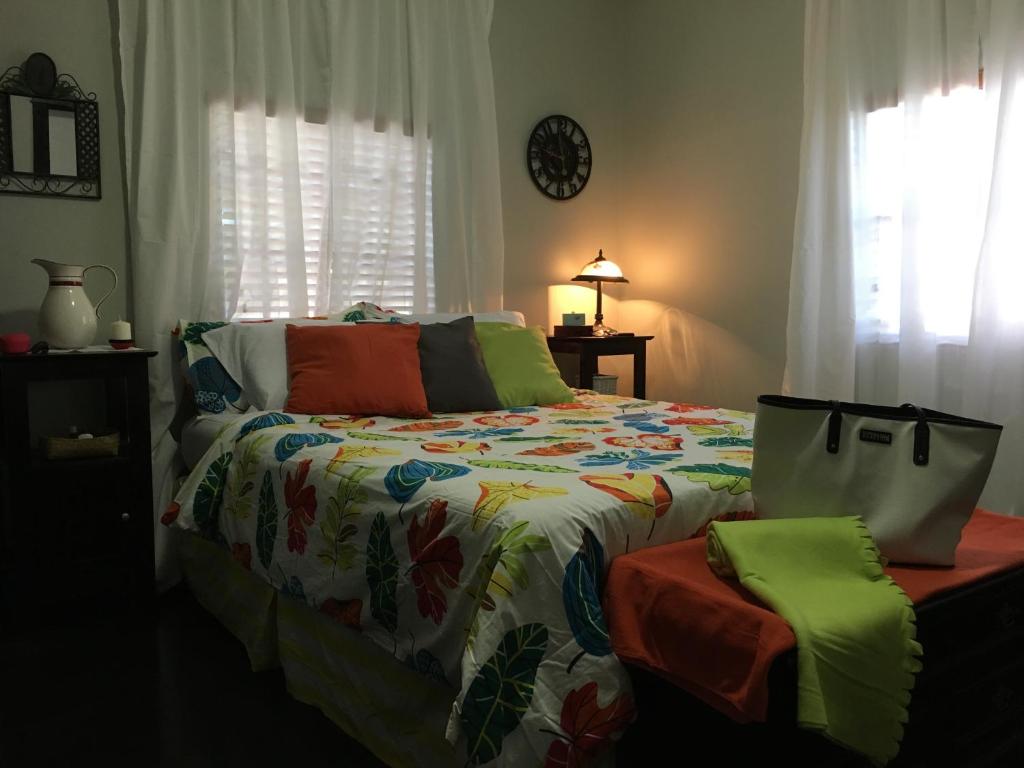 a bedroom with a bed with a colorful comforter at The Jewel of Little Havana - 2S in Miami