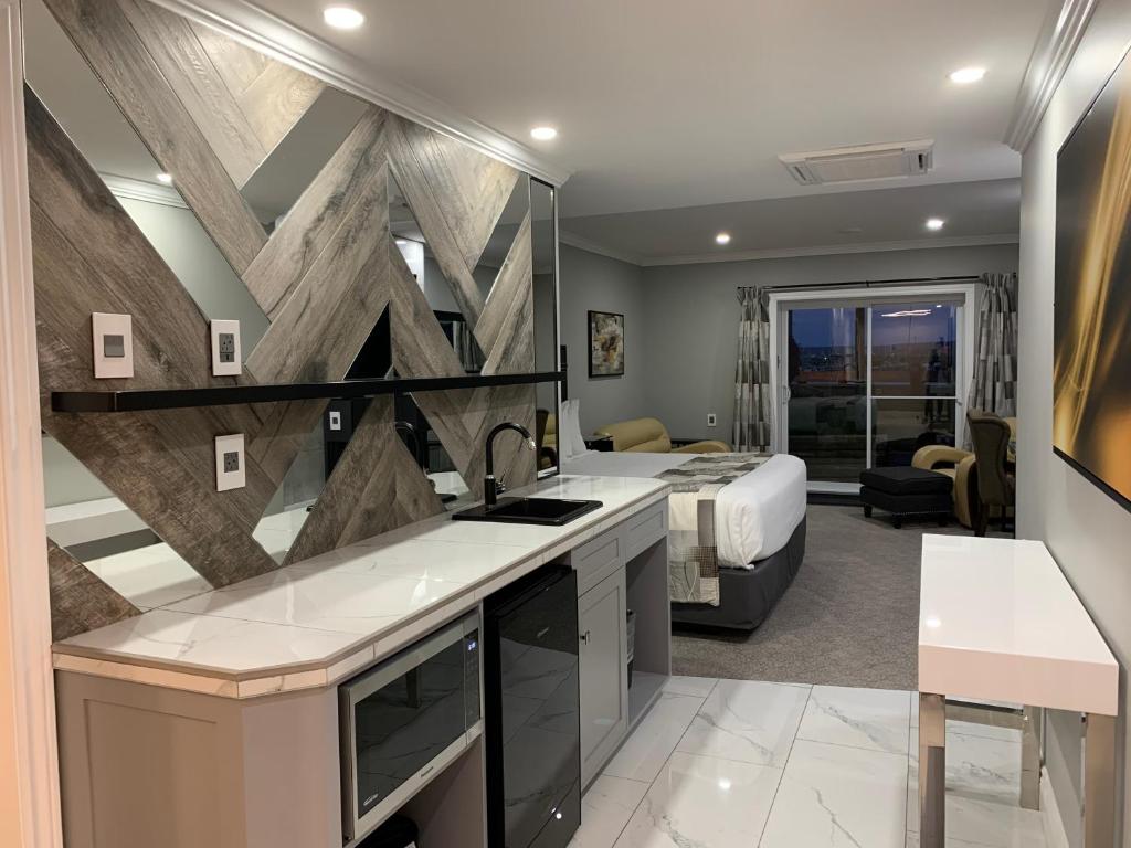 a kitchen and bedroom with a bed in a room at Dockside Suites in Digby