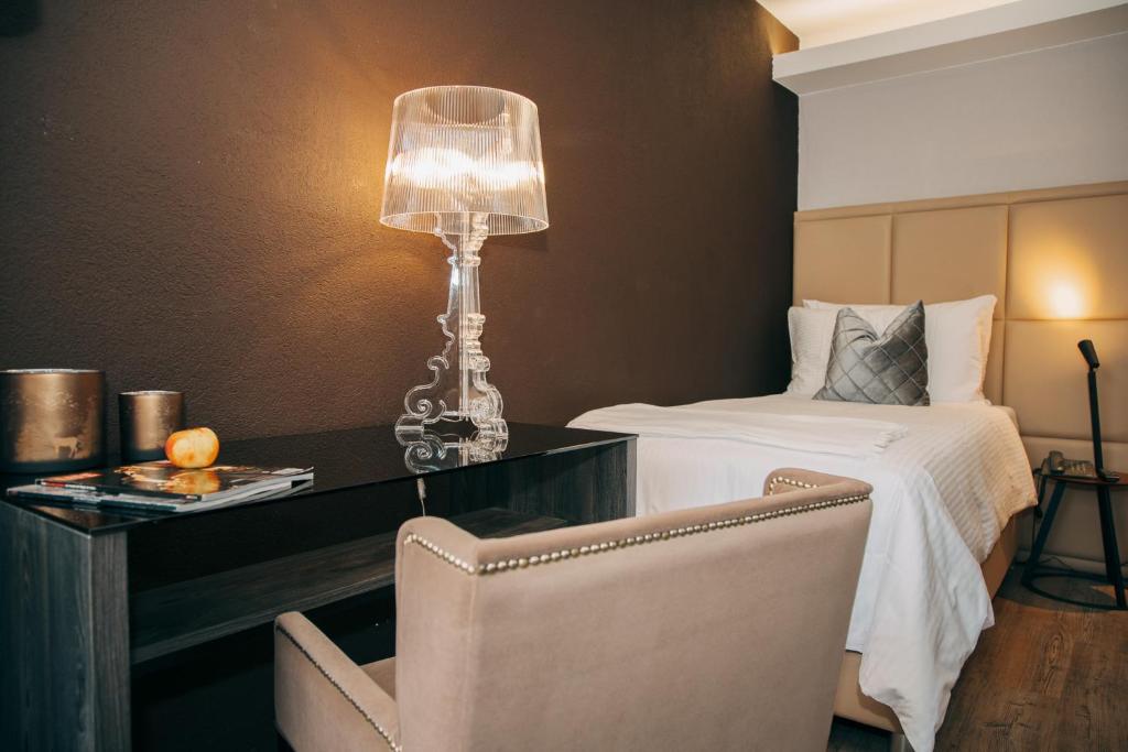 Postel nebo postele na pokoji v ubytování Hotel Dakota