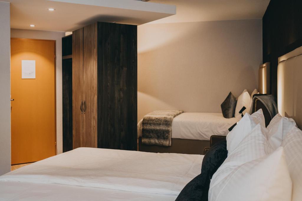 Postel nebo postele na pokoji v ubytování Hotel Dakota