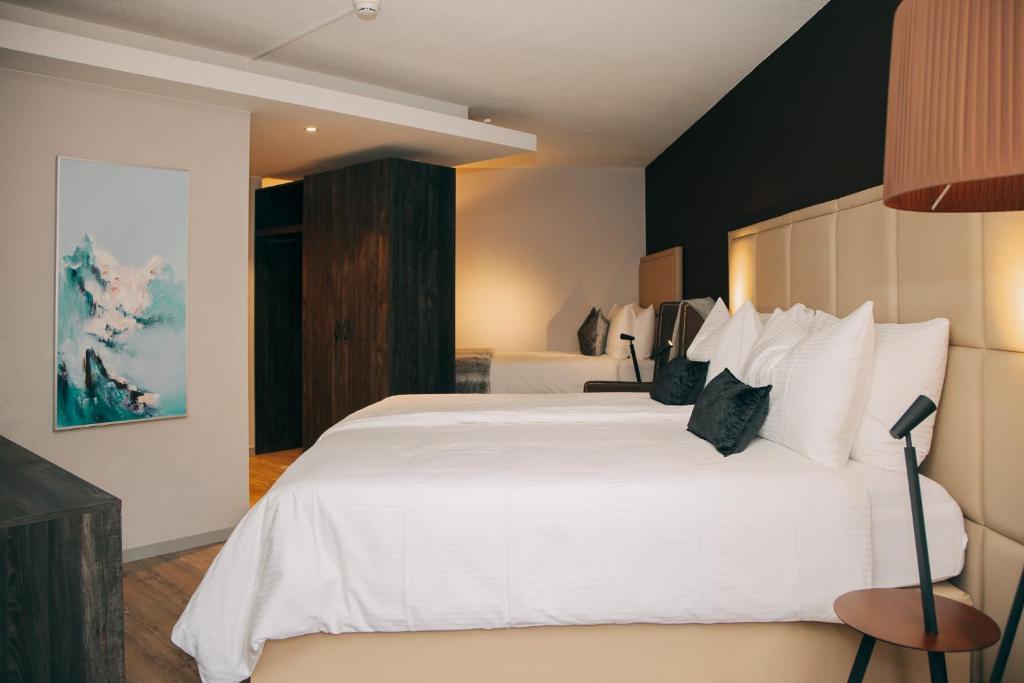 Postel nebo postele na pokoji v ubytování Hotel Dakota