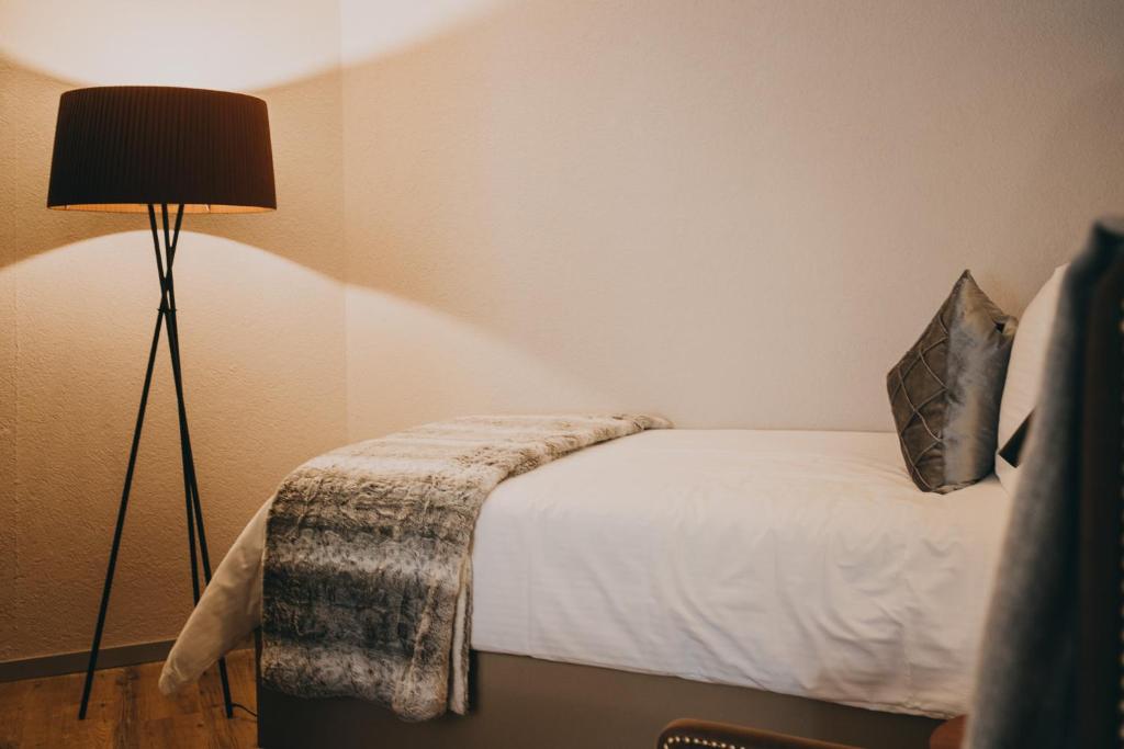 Postel nebo postele na pokoji v ubytování Hotel Dakota