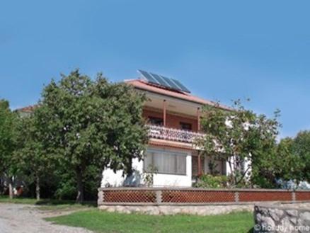 a house with solar panels on top of it at Apartment in Starigrad-Paklenica 6770 in Punta