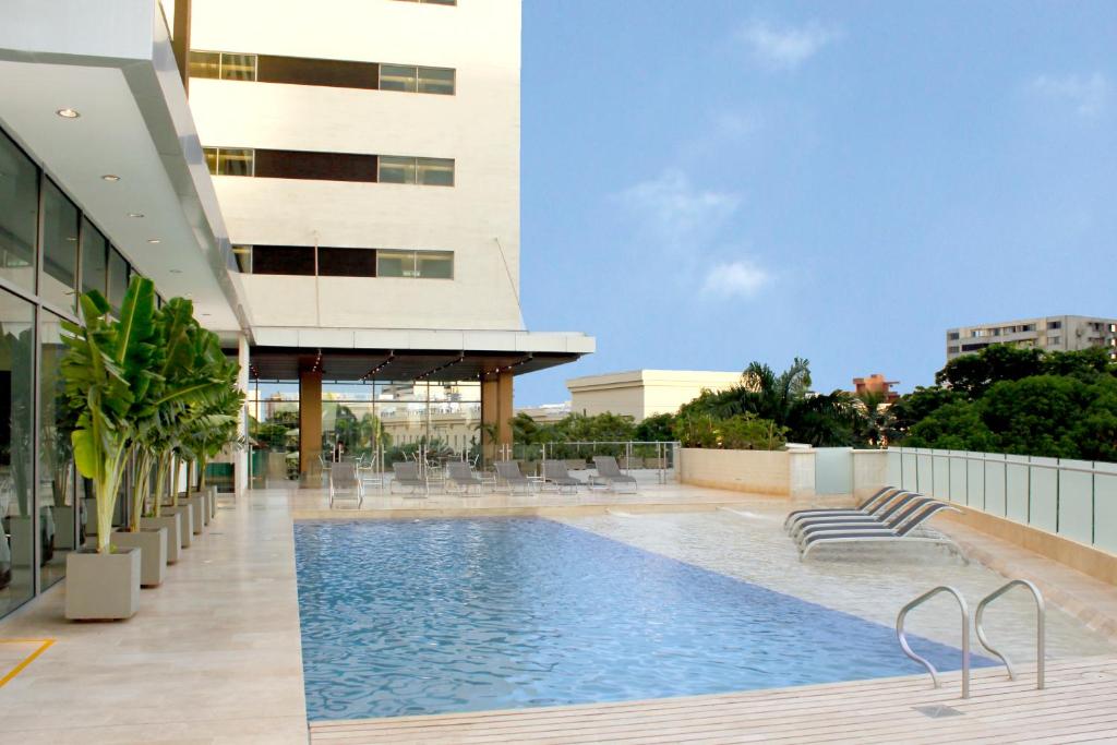 a swimming pool on the roof of a building at Estelar Apartamentos Barranquilla in Barranquilla