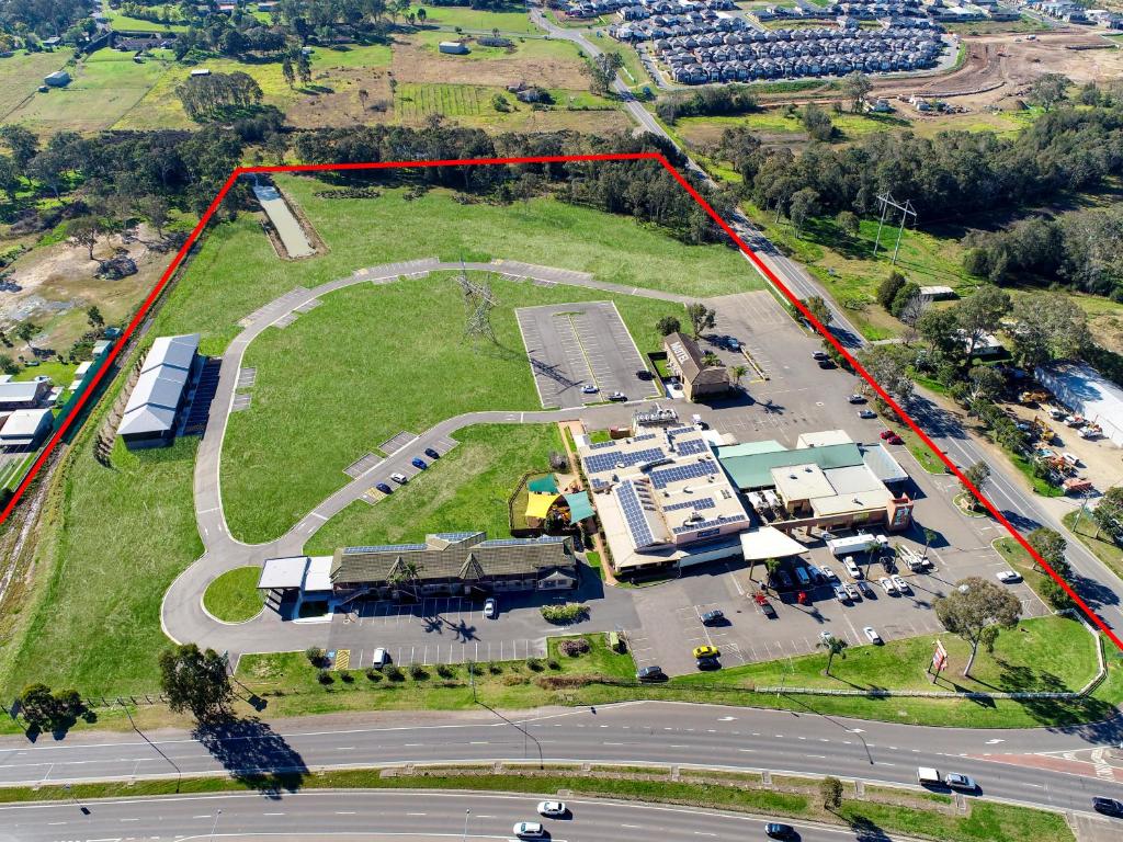 an aerial view of a parking lot with a building at Gateway Motel in Vineyard