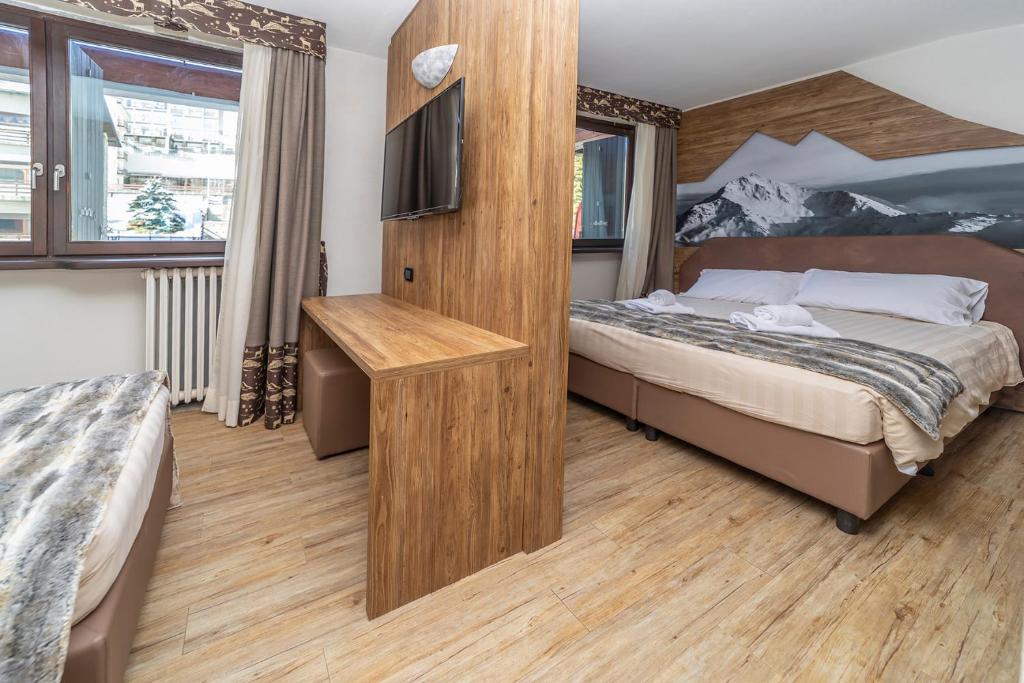 Postel nebo postele na pokoji v ubytování Hotel Du Col