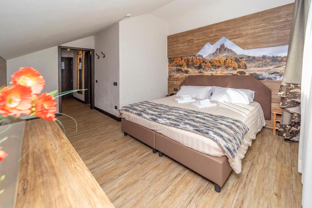 Postel nebo postele na pokoji v ubytování Hotel Du Col