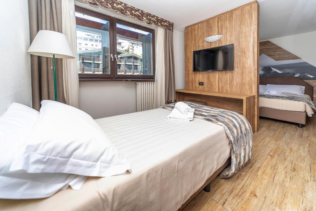 Postel nebo postele na pokoji v ubytování Hotel Du Col