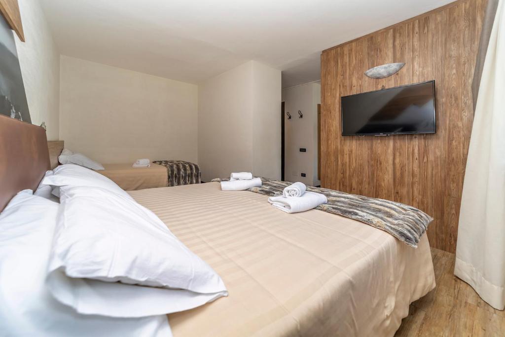 Postel nebo postele na pokoji v ubytování Hotel Du Col
