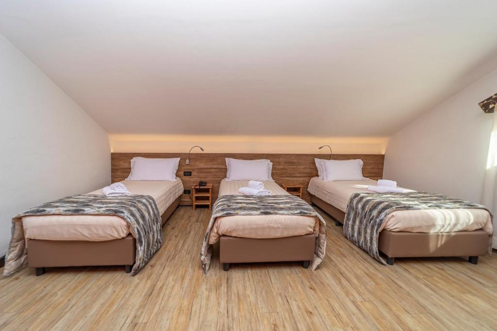 Postel nebo postele na pokoji v ubytování Hotel Du Col