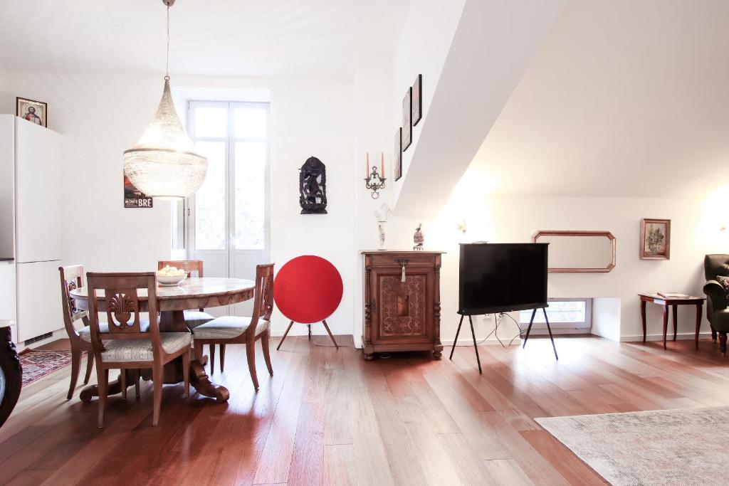 a living room with a table and a tv at Al Ciani Balcony Suite in Lugano