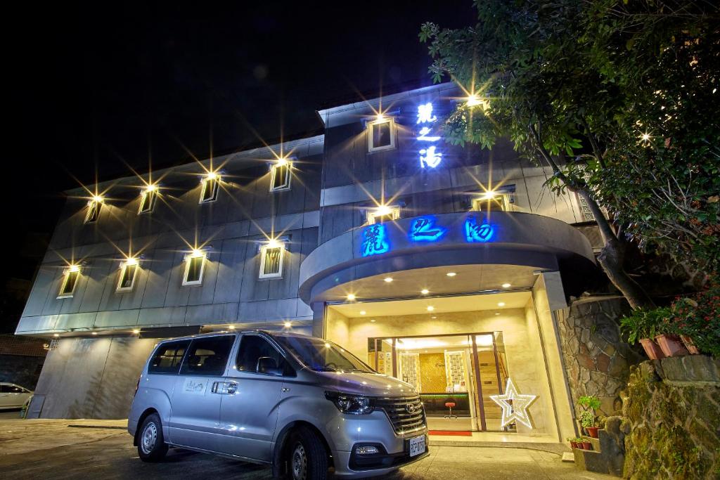 a suv parked in front of a building at night at Gorgeous Hot Spring Resort in Taipei