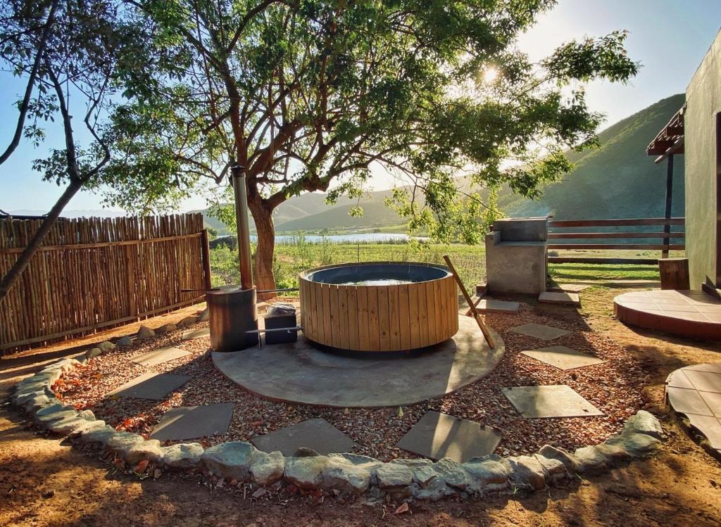 a fire pit in a yard with a tree at Pat Busch Mountain Reserve in Robertson