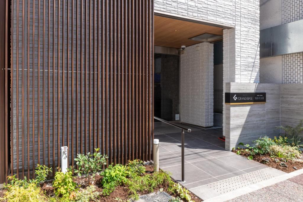 un ingresso a un edificio con un cartello sopra di GRAND BASE Hakata Naraya a Fukuoka