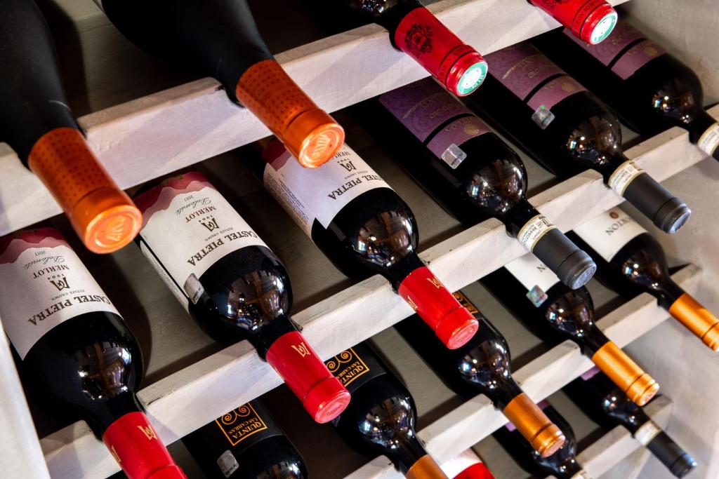 a bunch of wine bottles in a wine cellar at Karlamuiza Country Hotel in Kārļi