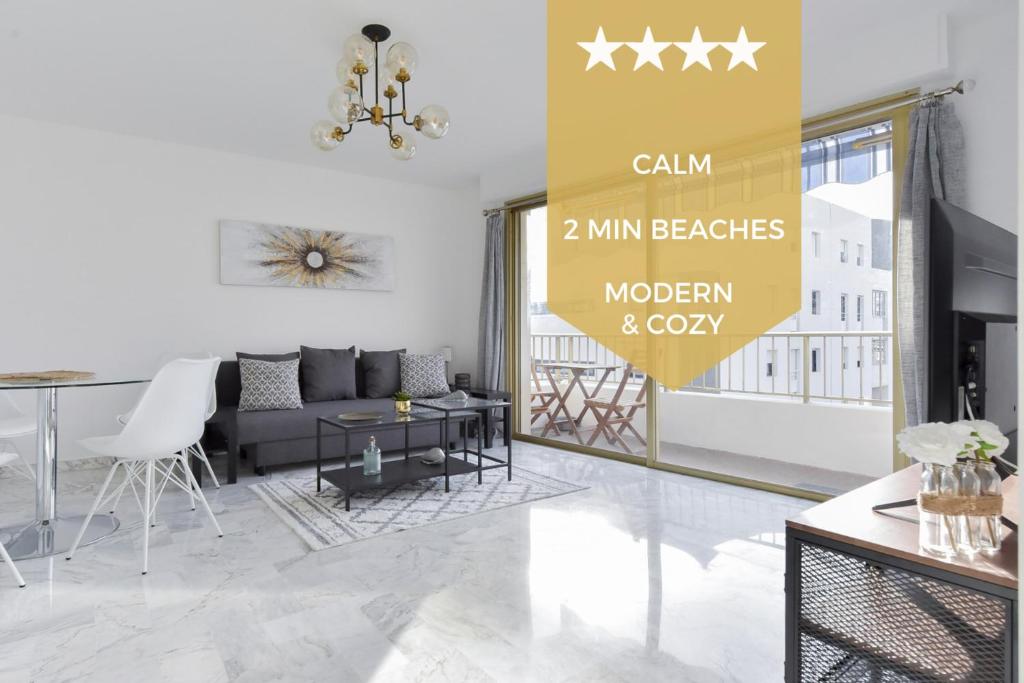 a living room with a couch and a table at SERRENDY Cannes Palm Beach 2min walk to beaches in Cannes