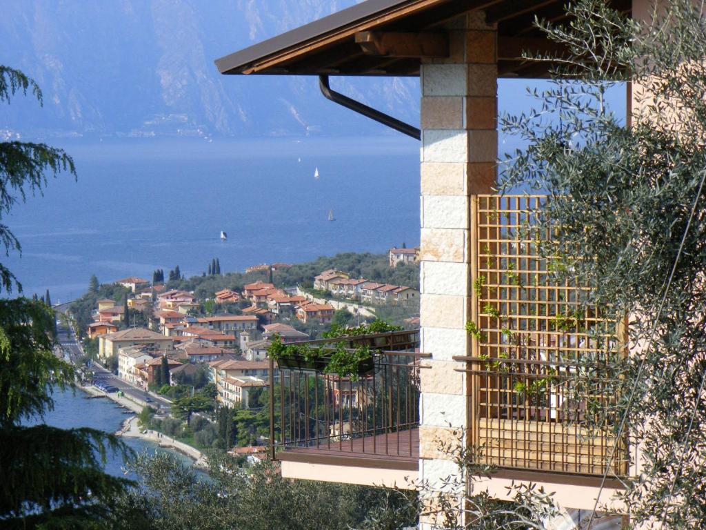 a balcony with a view of a town and the water at Casa Palmira in Brenzone sul Garda