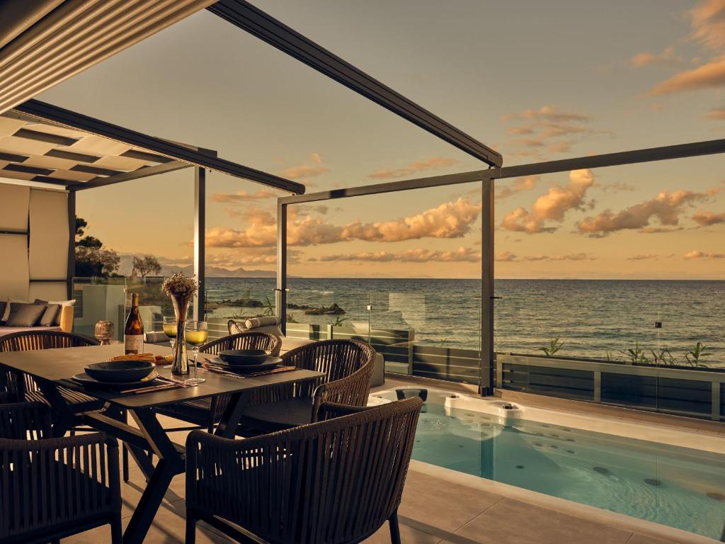 a dining room with a view of the ocean at Blue View Villa in Alikanas
