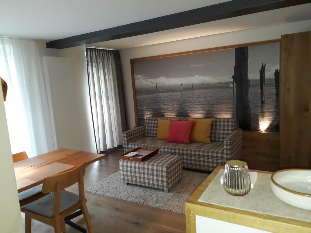 a living room with a couch and a table at Apartment am Kniebach in Immenstaad am Bodensee