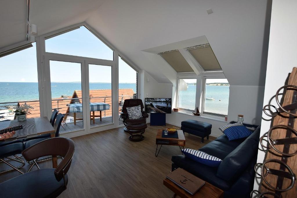 a living room with a view of the ocean at Meeresblick-Deck-44-Haus-3-WE-44 in Hohwacht