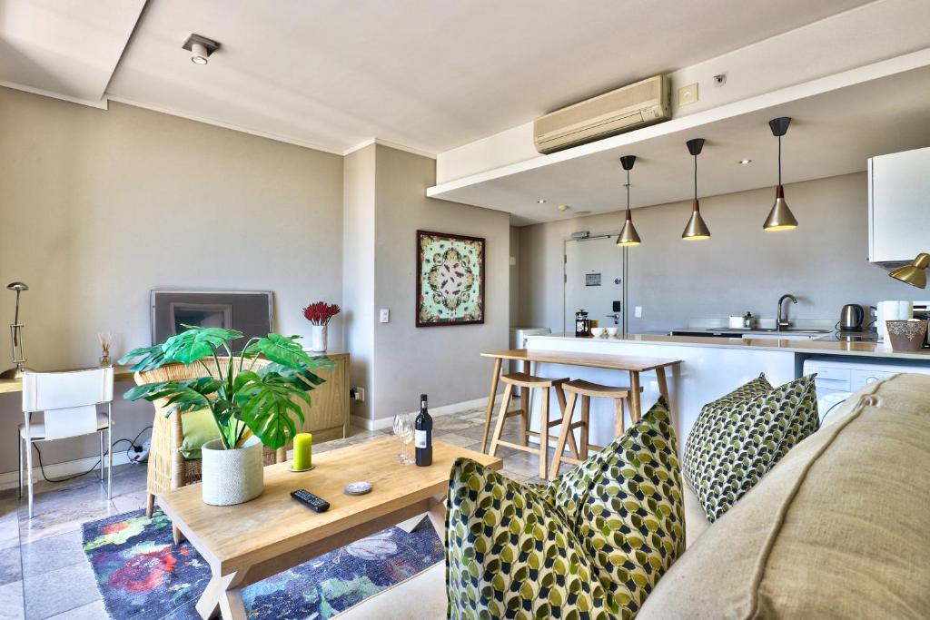 a living room with a couch and a table at Harbour Bridge 13A in Cape Town