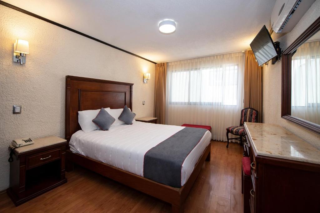 Postel nebo postele na pokoji v ubytování Hotel Senorial
