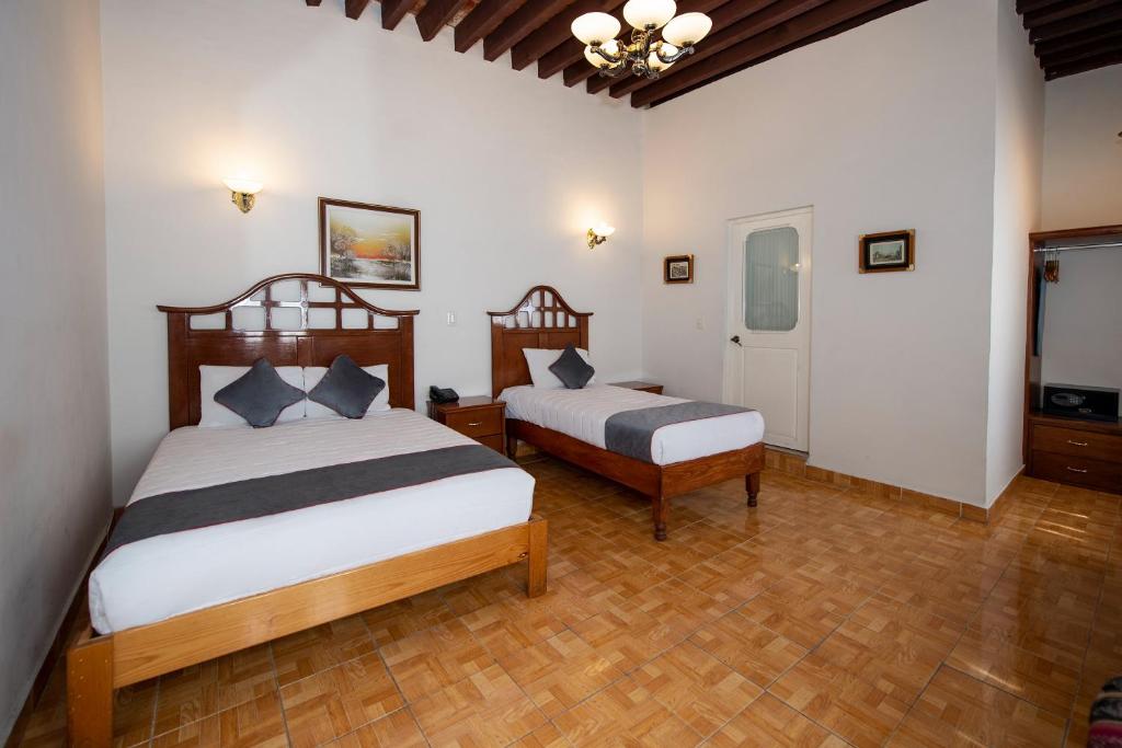 Postel nebo postele na pokoji v ubytování Hotel Senorial