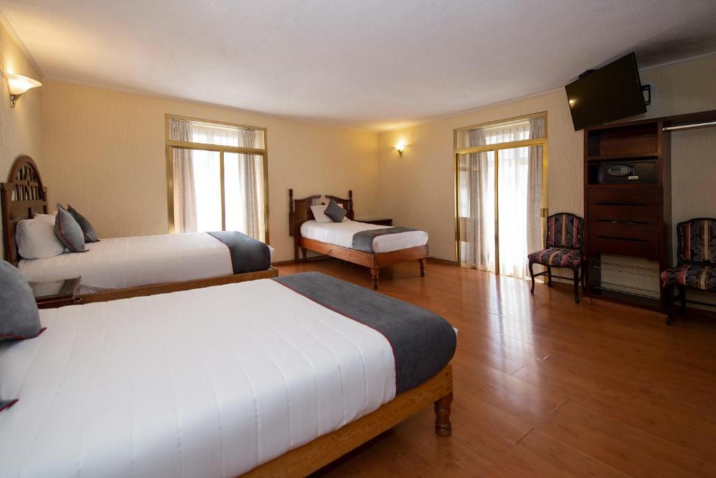 Postel nebo postele na pokoji v ubytování Hotel Senorial