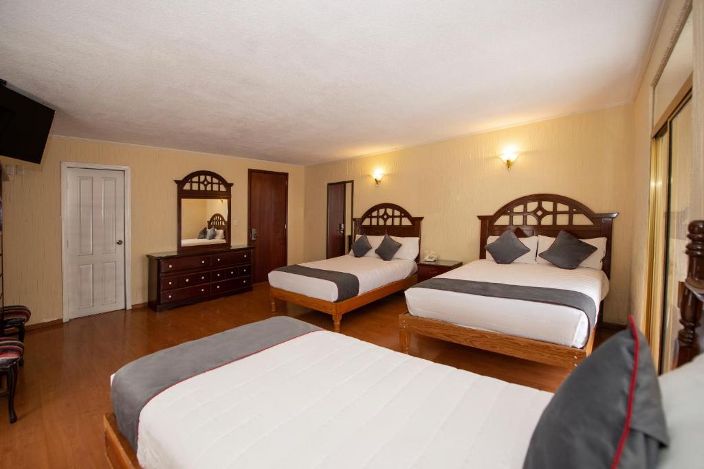 Postel nebo postele na pokoji v ubytování Hotel Senorial