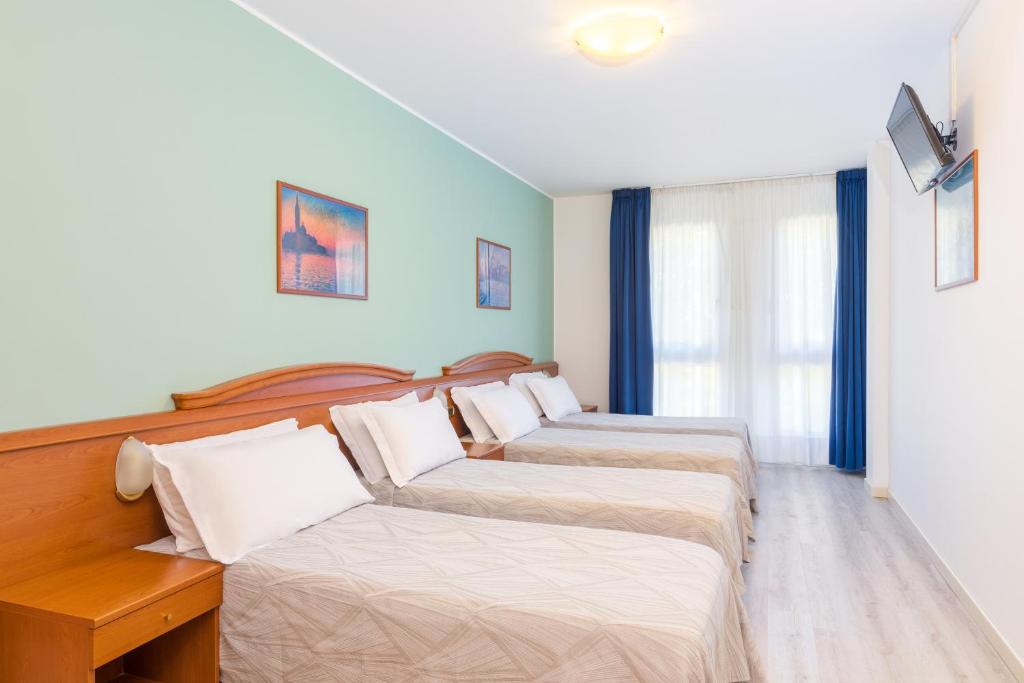 Postel nebo postele na pokoji v ubytování Hotel Palladio