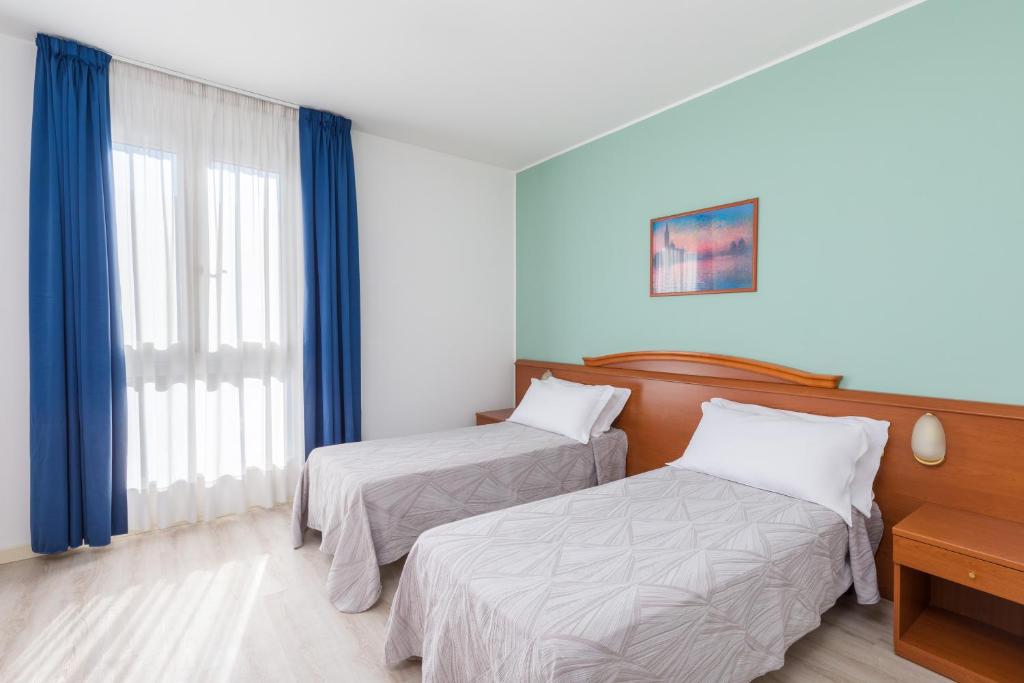 Postel nebo postele na pokoji v ubytování Hotel Palladio