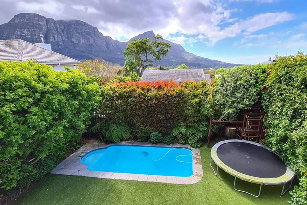 a swimming pool in the middle of a yard at Cape Town Lock-and-Go House Ideal for your Holiday in Cape Town