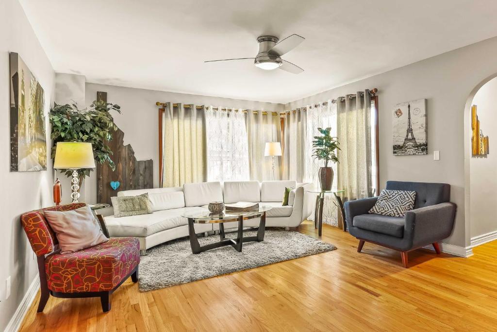 a living room with a white couch and chairs at Spacious Family Home with Garage Game Room and Office! in Boise