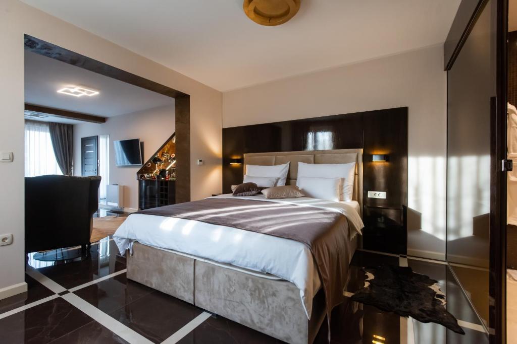 a bedroom with a large bed and a large mirror at Suites Kod Guste in Sukošan