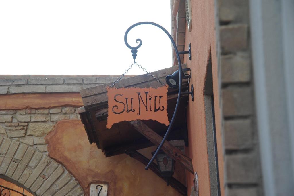 a sign that says ski music hanging on a building at Bed and Breakfast Su Niu in Quartucciu
