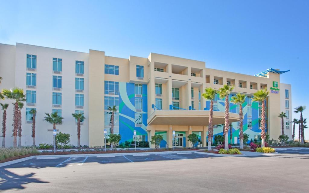a rendering of the front of a hotel with palm trees at Holiday Inn Resort Fort Walton Beach, an IHG Hotel in Fort Walton Beach