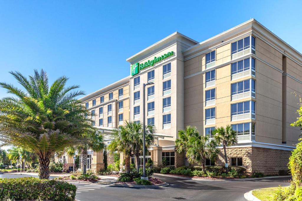 an exterior view of a hotel with palm trees at Holiday Inn Hotel & Suites Tallahassee Conference Center North, an IHG Hotel in Tallahassee