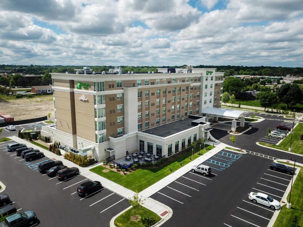 an aerial view of a hotel with a parking lot at Holiday Inn & Suites - Farmington Hills - Detroit NW, an IHG Hotel in Farmington Hills