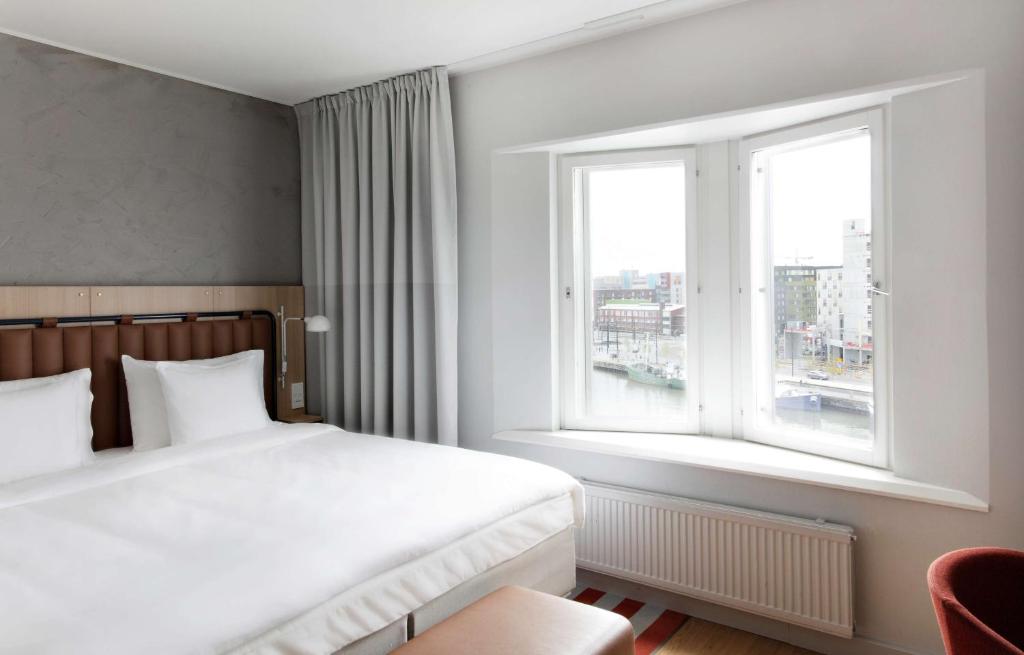 a bedroom with a white bed and a window at Radisson Blu Seaside Hotel, Helsinki in Helsinki