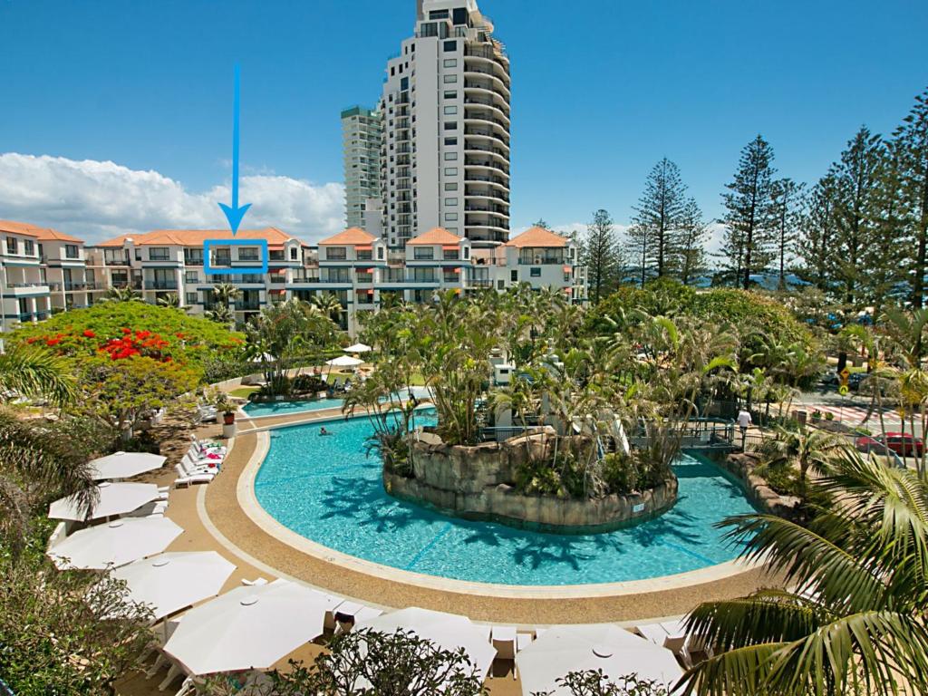 a resort with a swimming pool and a tall building at Calypso Plaza Resort Unit 417 in Gold Coast