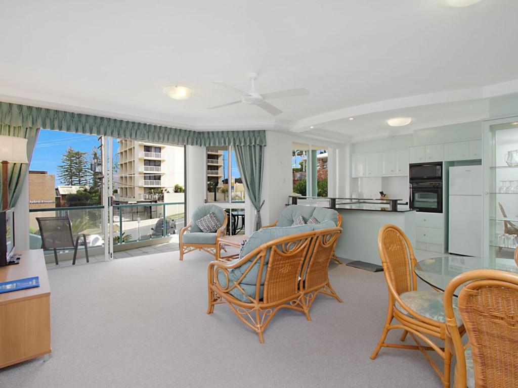 a kitchen and living room with a table and chairs at Classique Unit 3 in Gold Coast