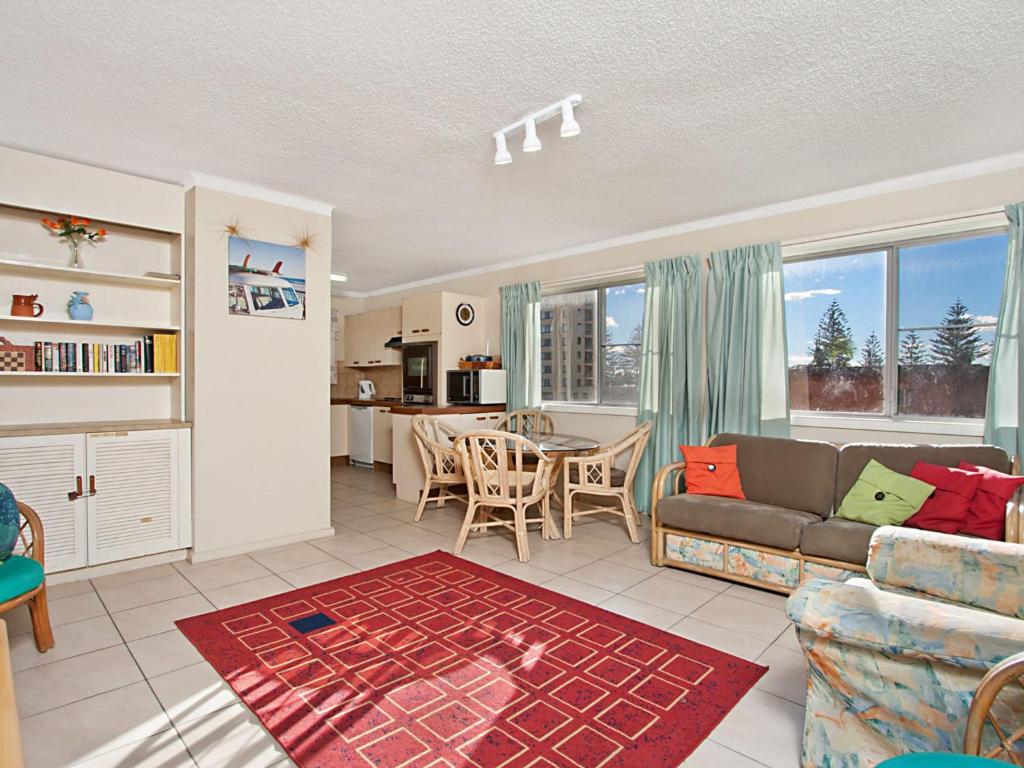 a living room with a couch and a table at Como Unit 5 in Gold Coast