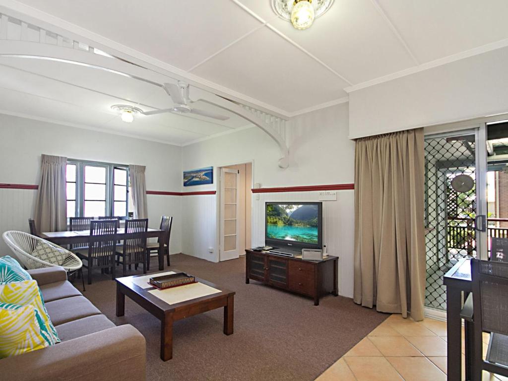 a living room with a couch and a tv at Tondio Terrace Flat 1 in Gold Coast