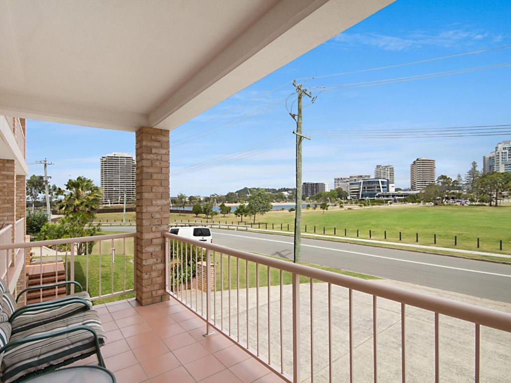 a balcony with chairs and a view of a street at Tumut Unit 1 in Coolangatta